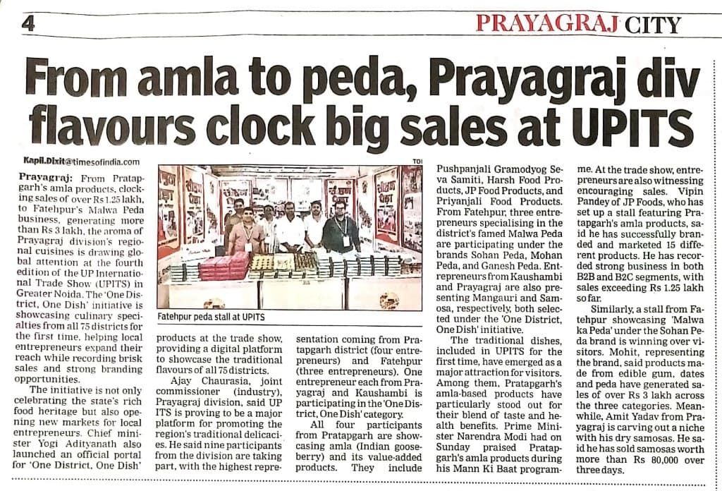 Times of India Prayagraj City page, “From amla to peda, Prayagraj div flavours clock big sales at UPITS,” with a photograph captioned “Fatehpur peda stall at UPITS.”